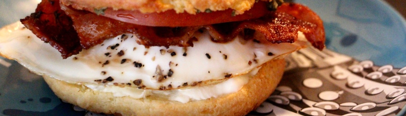 Keto LCHF bagel with egg, bacon, tomato, cream cheese and pesto